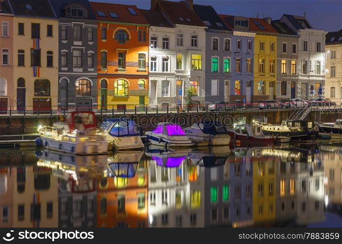 Embankment of the river Leie with reflections colored houses in Ghent town at night, Belgium