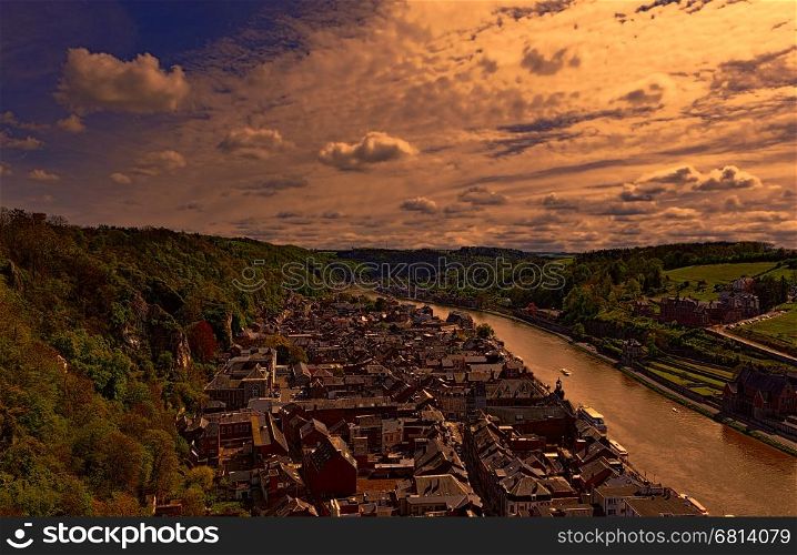 Embankment of the River Meuse in the Belgian City of Dinant at sunset. Beautiful small town Dinant in Belgium.