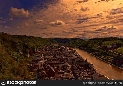 Embankment of the River Meuse in the Belgian City of Dinant at sunset. Beautiful small town Dinant in Belgium.