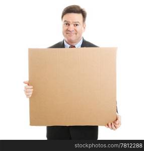 Embarrassed jobless businessman holding up a blank cardboard sign. Isolated on white.