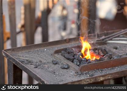 embers, fire, smoke and blacksmith tools