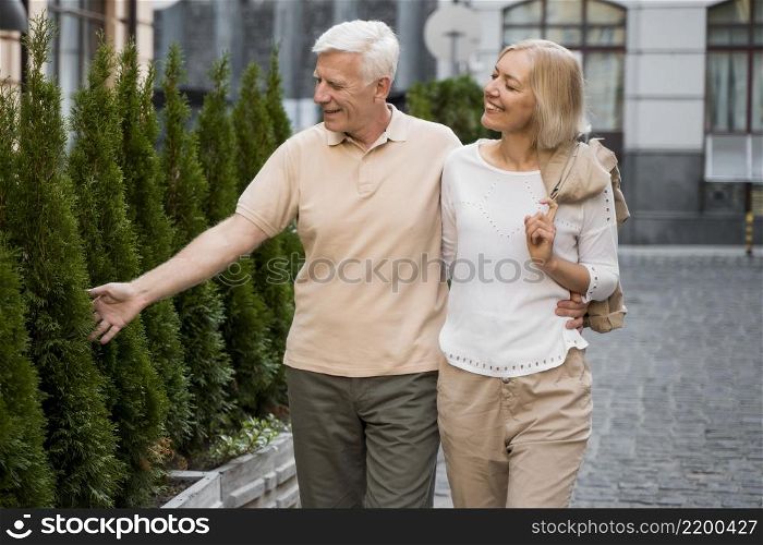 embrace older couple taking walk outdoors