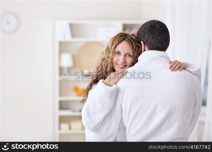 Embracing a married couple in dressing gowns
