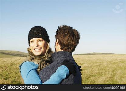 Embracing couple in countryside