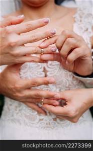 Embracing the hands of the newlyweds on a sunny summer day.. A tender photo of touching touches of the newlyweds 3810.