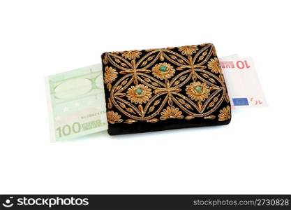 Embroidered woman&rsquo;s purse and euro banknotes isolated