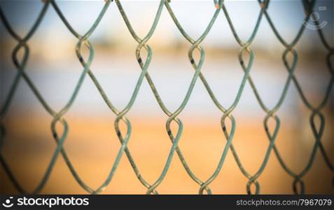 embroidery of a metal fence. In fronte of a metal industrial fence