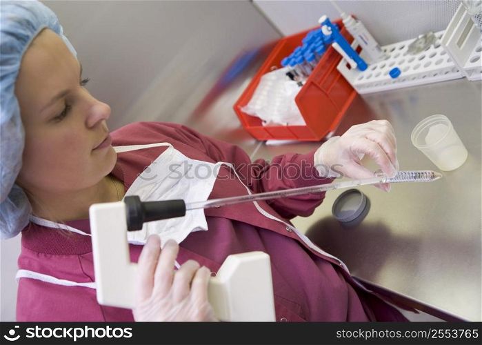Embryologist doing an intra cytoplasmic sperm injection (selective focus)