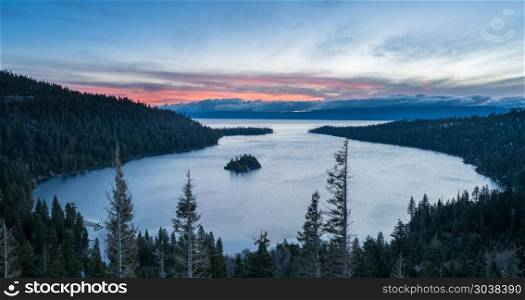 Emerald Bay on Lake Tahoe with snow on mountains. Sunrise at Emerald Bay on Lake Tahoe between California and Nevada with snow covered Sierra Nevada Mountains. Emerald Bay on Lake Tahoe with snow on mountains