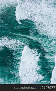 Emerald green ocean waves aerial drone top view