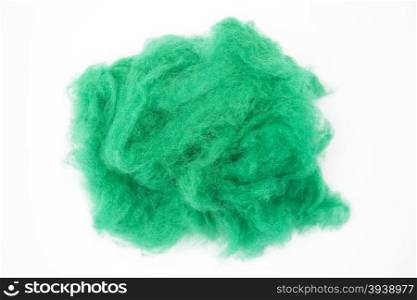 Emerald green piece of Australian sheep wool Merino breed close-up on a white background. Emerald green piece of Australian sheep wool Merino breed close-up on a white background.
