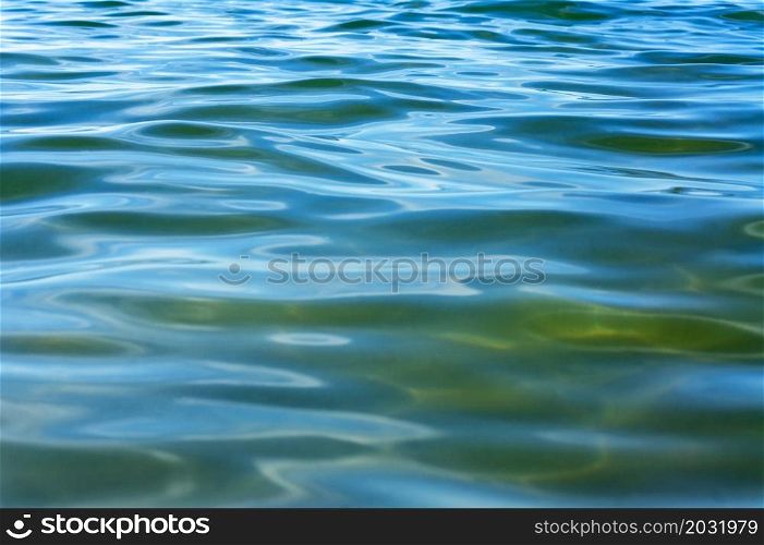 Emerald green water surface. The background is water. Sea water.. The background is water. Sea water. Emerald green water surface.