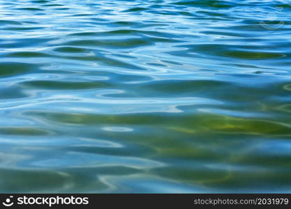 Emerald green water surface. The background is water. Sea water.. The background is water. Sea water. Emerald green water surface.