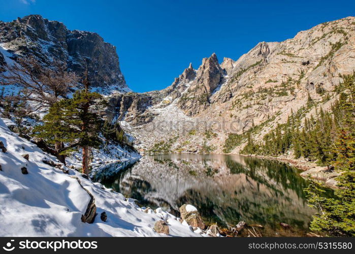 Emerald Lake and reflection with rocks and mountains in snow around at autumn. Rocky Mountain National Park in Colorado, USA.