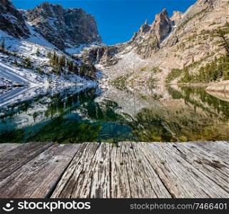 Emerald Lake and reflection with rocks and mountains in snow around at autumn. Rocky Mountain National Park in Colorado, USA. 