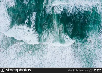 Emerald ocean waves aerial drone top view