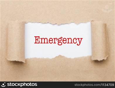 Emergency concept text appearing behind torn brown paper envelope