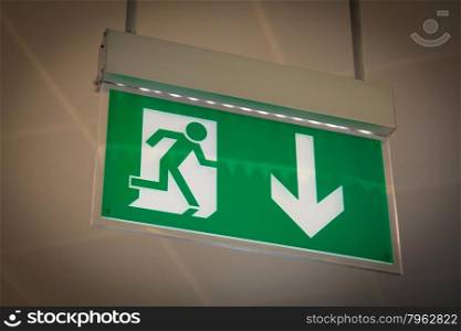 Emergency exit sign above a black doorway