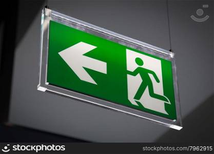 Emergency exit sign above a black doorway