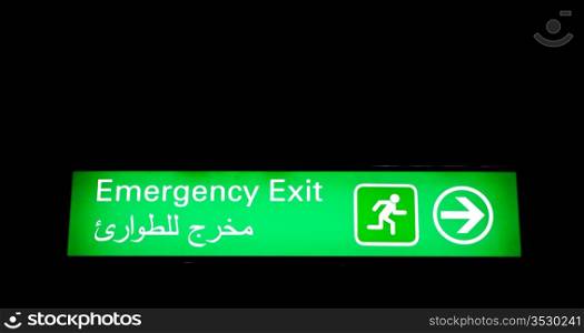 Emergency exit sign in an international airport in Middle East with Arabic information