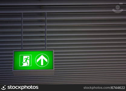 Emergency exit sign in modern offices inside an industrial plant