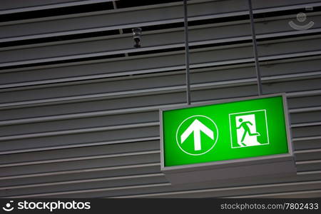 Emergency exit sign in modern offices inside an industrial plant