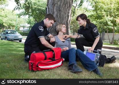 Emergency medical professionals assessing an injured patient on the street