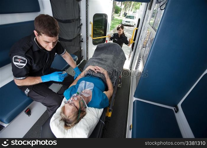 Emergency medical professionals caring for senior patient