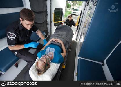 Emergency medical professionals caring for senior patient