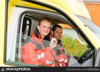 Emergency paramedic in ambulance car talk radio smiling confident