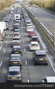 Emergency services closing motorway to attend accident causing a traffic jam