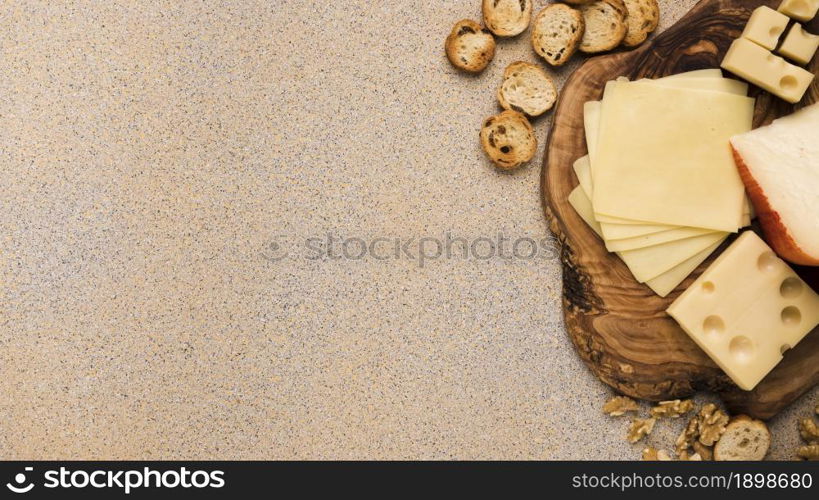 emmental cheese gouda cheese with slices coaster with bread slices walnut beige textured backdrop. Resolution and high quality beautiful photo. emmental cheese gouda cheese with slices coaster with bread slices walnut beige textured backdrop. High quality beautiful photo concept