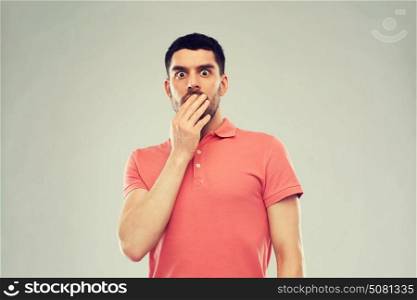 emotion, advertisement and people concept - scared man in polo t-shirt over gray background. scared man in polo t-shirt over gray background