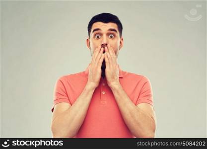 emotion, advertisement and people concept - scared man in polo t-shirt over gray background. scared man in polo t-shirt over gray background. scared man in polo t-shirt over gray background