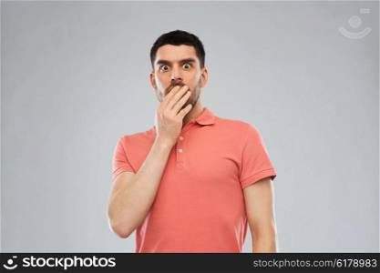 emotion, advertisement and people concept - scared man in polo t-shirt over gray background
