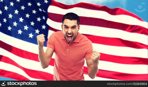 emotion, aggression, patriotism, gesture and people concept - angry young man showing fists over american flag. angry man showing fists over american flag. angry man showing fists over american flag