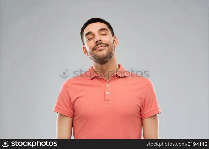emotion and people concept - laughing man in polo t-shirt over gray background. laughing man over gray background