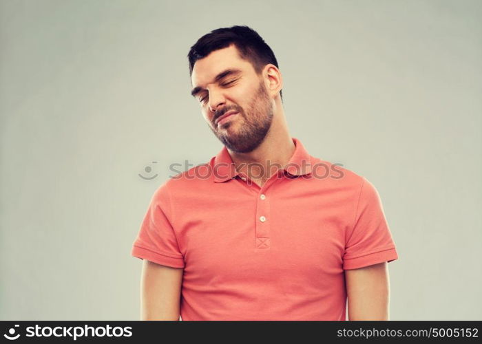 emotion and people concept - young wrying man over gray background. man wrying over gray background