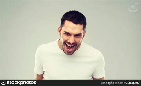 emotion, cruelty, anger and people concept - angry man over gray background. angry man over gray background