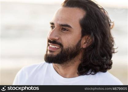 emotion, expression and people concept - happy smiling man with beard outdoors