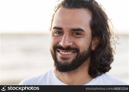 emotion, expression and people concept - happy smiling man with beard outdoors