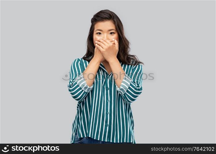 emotion, expression and people concept - scared or surprised asian woman over grey background. scared asian woman over grey background