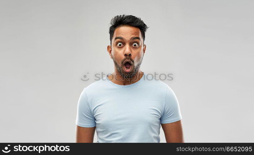 emotion, expression and people concept - shocked or scared man in t-shirt over grey background. shocked or scared man over grey background