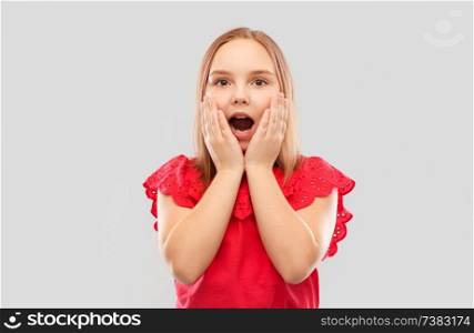 emotion, expression and people concept - shocked or surprised girl in red shirt with open mouth over grey background. shocked girl in with open mouth