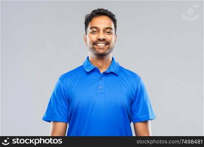 emotion, expression and people concept - smiling indian man in blue polo shirt over gray background. indian man in blue polo shirt over gray background