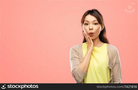 emotion, expression and people concept - surprised asian woman over pink living coral background. surprised asian woman over grey background