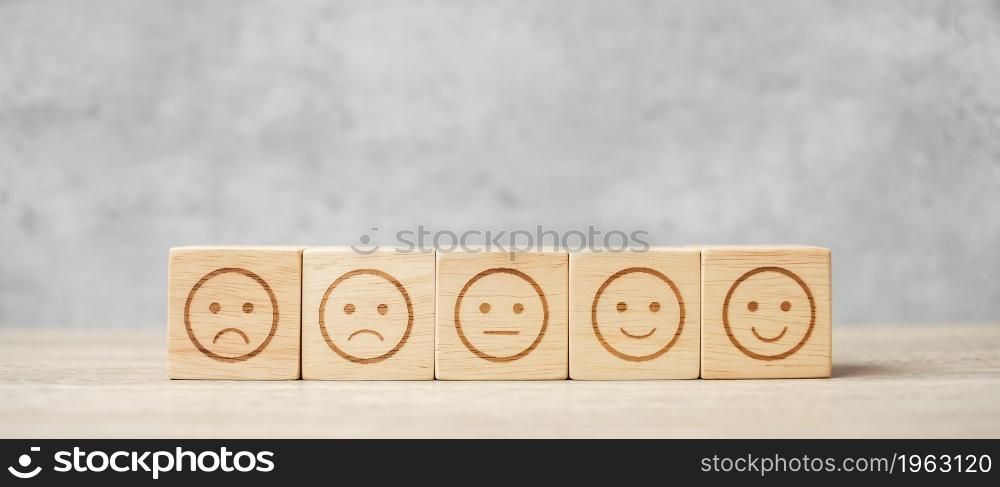emotion face symbol on wooden blocks. mood, Service rating, ranking, customer review, satisfaction, evaluation and feedback concept