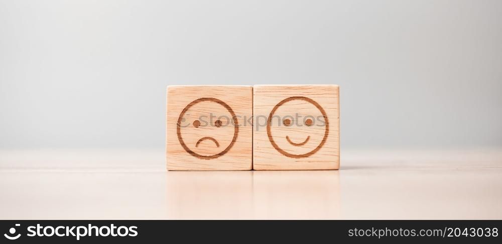 emotion face symbol on wooden blocks. Service rating, ranking, customer review, satisfaction, evaluation and feedback concept