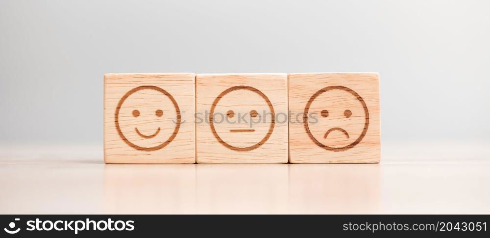 emotion face symbol on wooden blocks. Service rating, ranking, customer review, satisfaction, evaluation and feedback concept