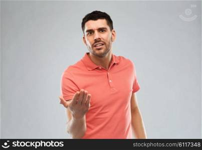 emotion, gesture, argue and people concept - arguing angry man proving something over gray